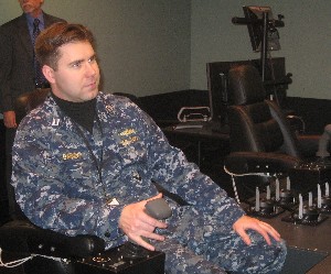 Lt. Phil Garrow, USN, demonstrates the Littoral Combat Ship bridge trainer at the Surface Warfare Officers School in March.